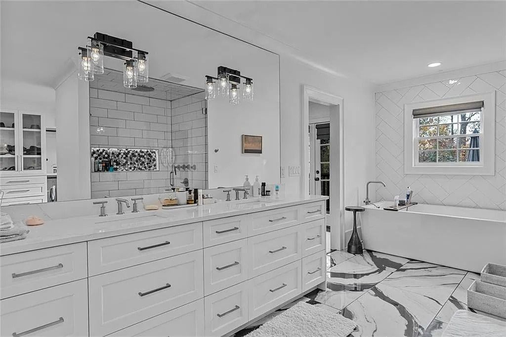 The House in Atlanta offers the lush green resort-style outdoor living with the saltwater heated pool and spa, dramatic lounge-side fireplace, and more now available for sale. This home located at 172 Blackland Dr NW, Atlanta, Georgia