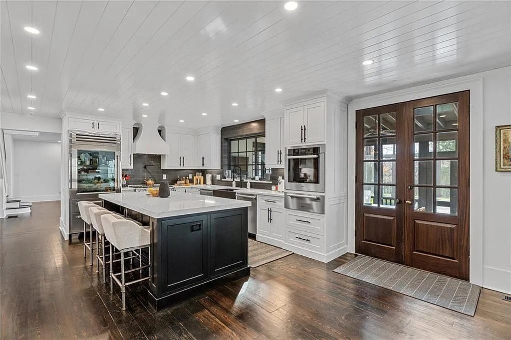 The House in Atlanta offers the lush green resort-style outdoor living with the saltwater heated pool and spa, dramatic lounge-side fireplace, and more now available for sale. This home located at 172 Blackland Dr NW, Atlanta, Georgia