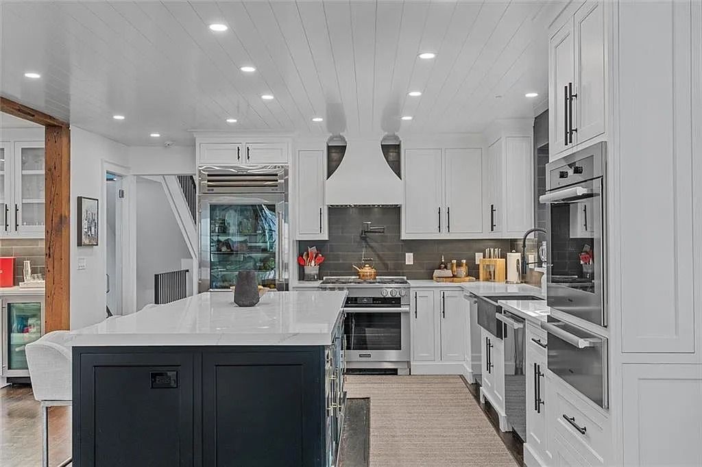The House in Atlanta offers the lush green resort-style outdoor living with the saltwater heated pool and spa, dramatic lounge-side fireplace, and more now available for sale. This home located at 172 Blackland Dr NW, Atlanta, Georgia