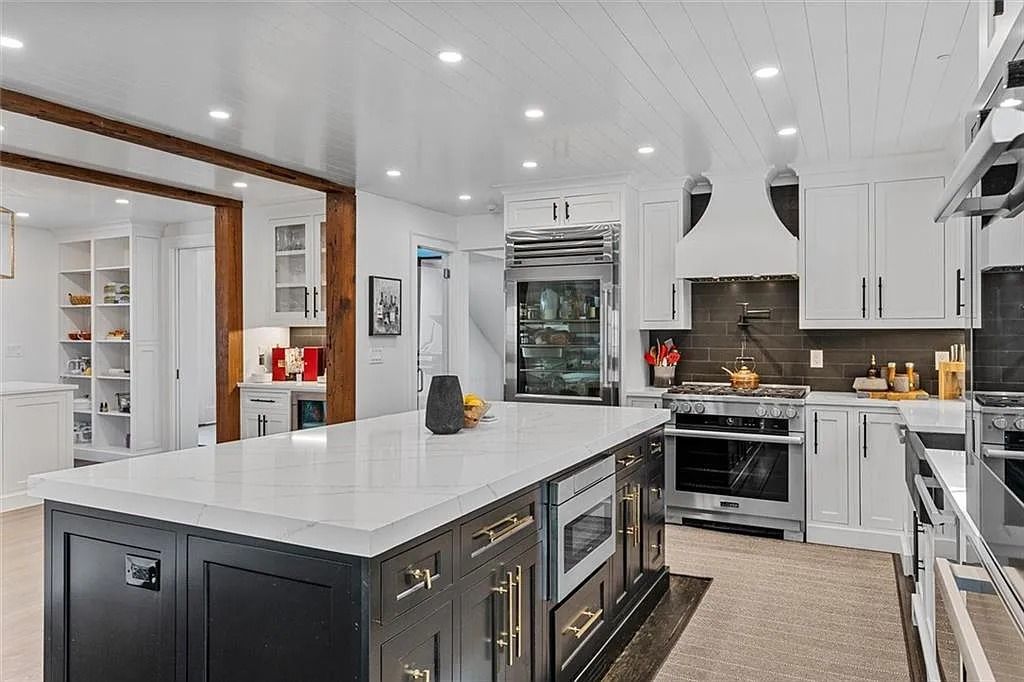 The House in Atlanta offers the lush green resort-style outdoor living with the saltwater heated pool and spa, dramatic lounge-side fireplace, and more now available for sale. This home located at 172 Blackland Dr NW, Atlanta, Georgia