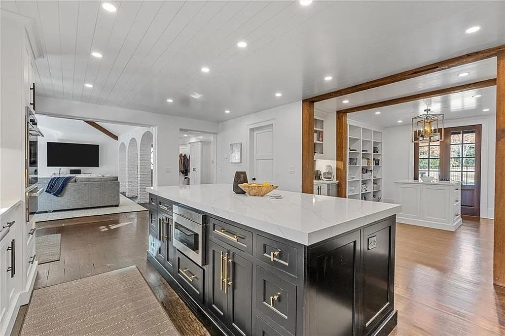The House in Atlanta offers the lush green resort-style outdoor living with the saltwater heated pool and spa, dramatic lounge-side fireplace, and more now available for sale. This home located at 172 Blackland Dr NW, Atlanta, Georgia