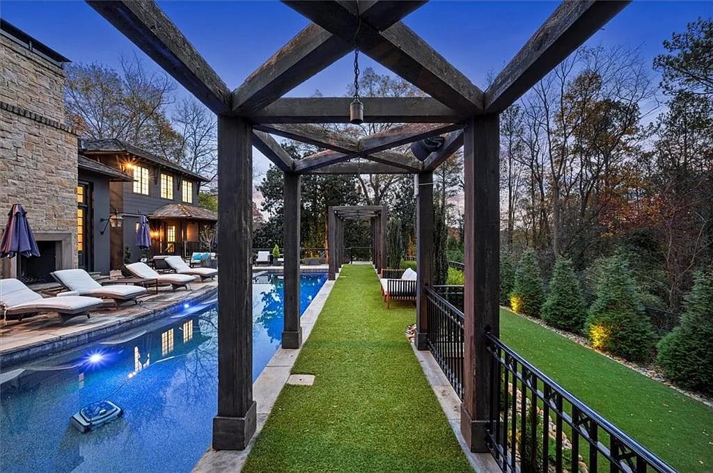 The House in Atlanta offers the lush green resort-style outdoor living with the saltwater heated pool and spa, dramatic lounge-side fireplace, and more now available for sale. This home located at 172 Blackland Dr NW, Atlanta, Georgia