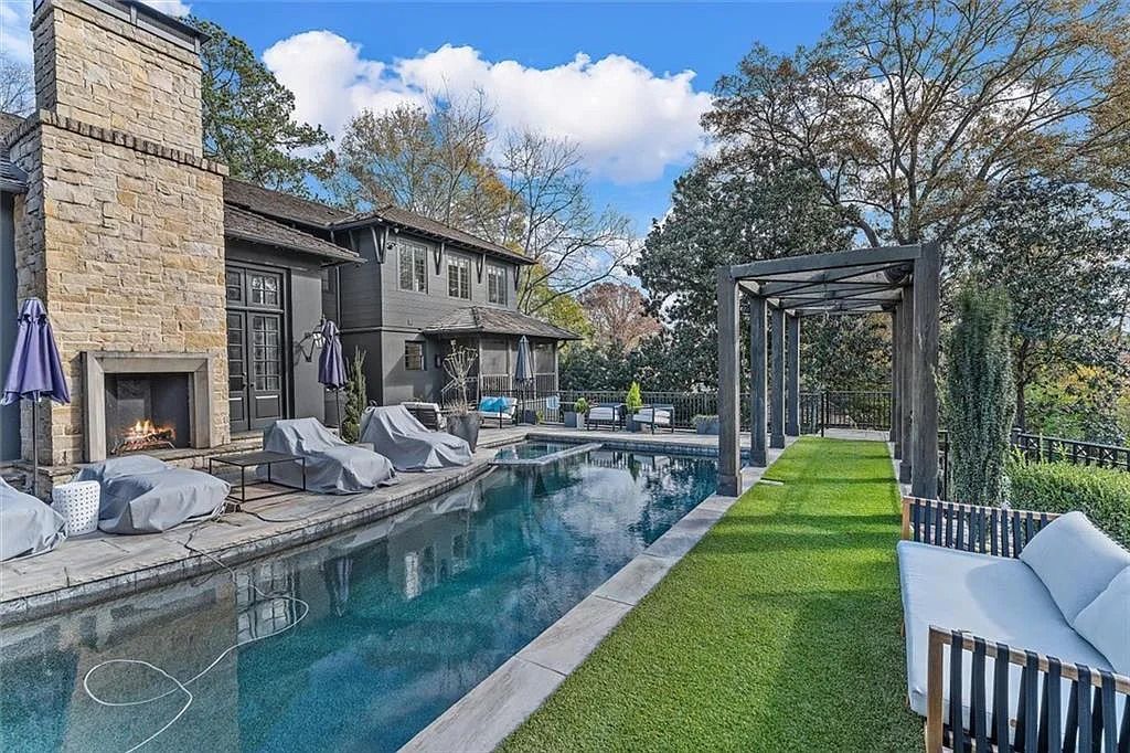 The House in Atlanta offers the lush green resort-style outdoor living with the saltwater heated pool and spa, dramatic lounge-side fireplace, and more now available for sale. This home located at 172 Blackland Dr NW, Atlanta, Georgia