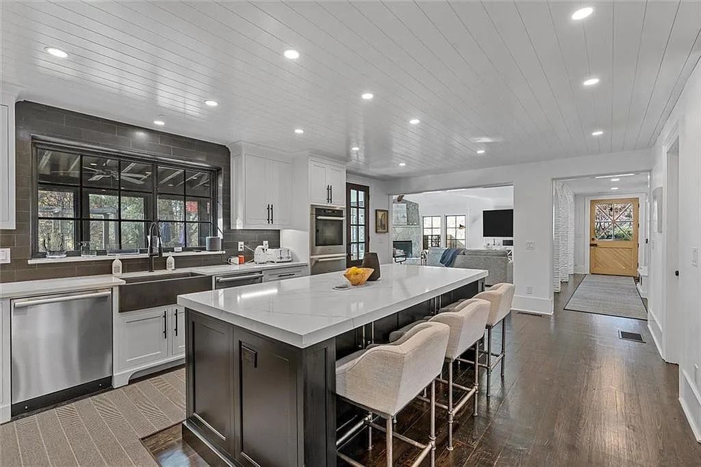 The House in Atlanta offers the lush green resort-style outdoor living with the saltwater heated pool and spa, dramatic lounge-side fireplace, and more now available for sale. This home located at 172 Blackland Dr NW, Atlanta, Georgia
