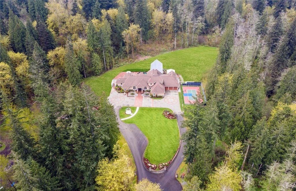 The Estate in Maple Valley boasts striking 22’ ceilings, library, home theater, gym, conference room, and an elevator to all three floors, now available for sale. This home located at 21145 212th Avenue SE, Maple Valley, Washington