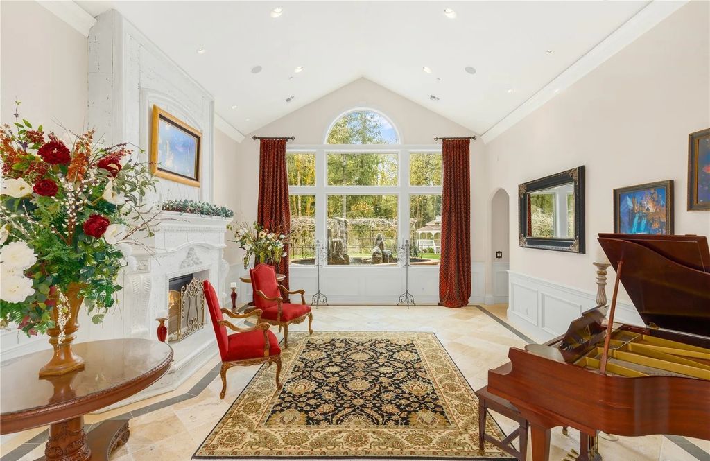The Estate in Maple Valley boasts striking 22’ ceilings, library, home theater, gym, conference room, and an elevator to all three floors, now available for sale. This home located at 21145 212th Avenue SE, Maple Valley, Washington