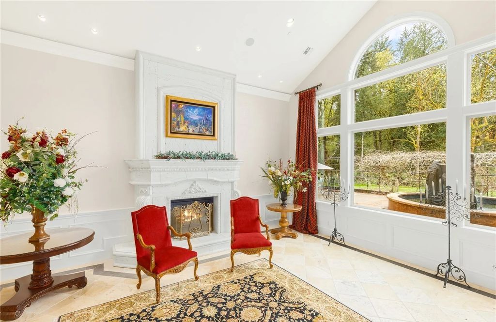 The Estate in Maple Valley boasts striking 22’ ceilings, library, home theater, gym, conference room, and an elevator to all three floors, now available for sale. This home located at 21145 212th Avenue SE, Maple Valley, Washington