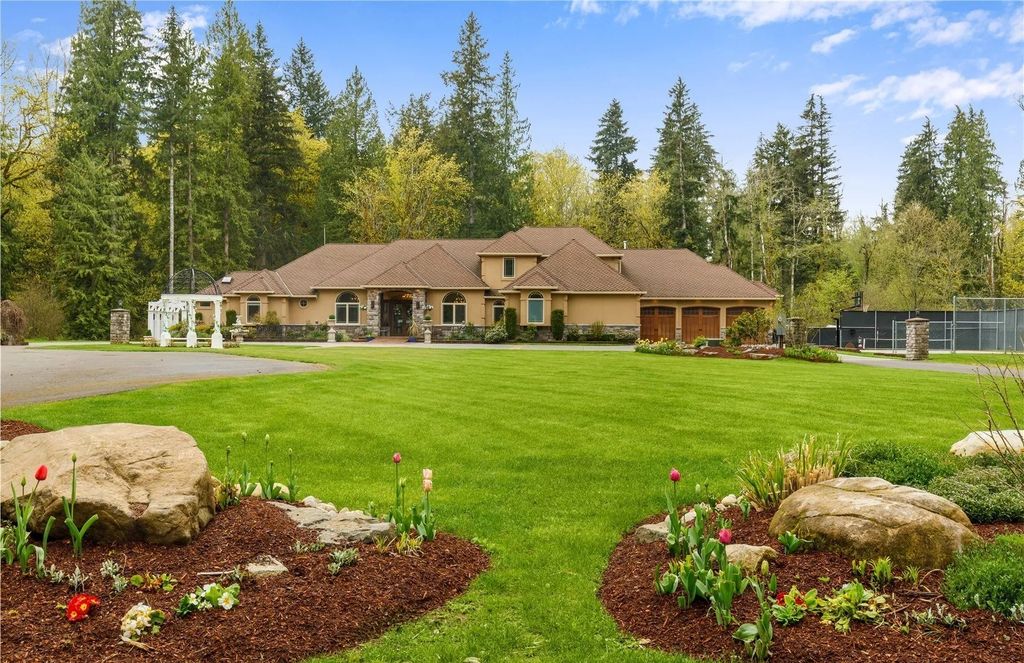 The Estate in Maple Valley boasts striking 22’ ceilings, library, home theater, gym, conference room, and an elevator to all three floors, now available for sale. This home located at 21145 212th Avenue SE, Maple Valley, Washington