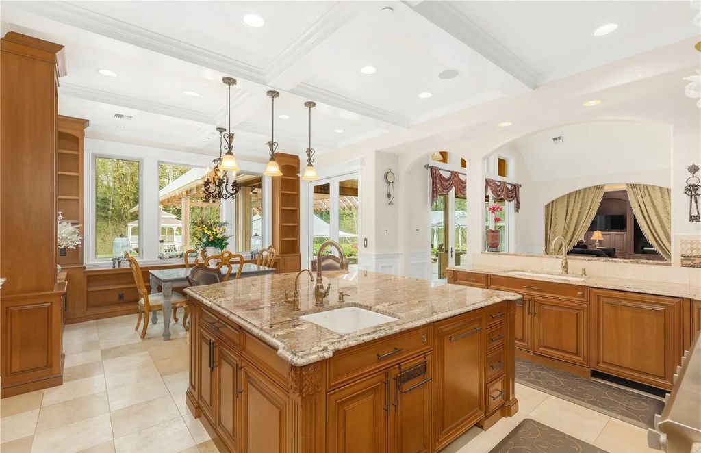 The Estate in Maple Valley boasts striking 22’ ceilings, library, home theater, gym, conference room, and an elevator to all three floors, now available for sale. This home located at 21145 212th Avenue SE, Maple Valley, Washington