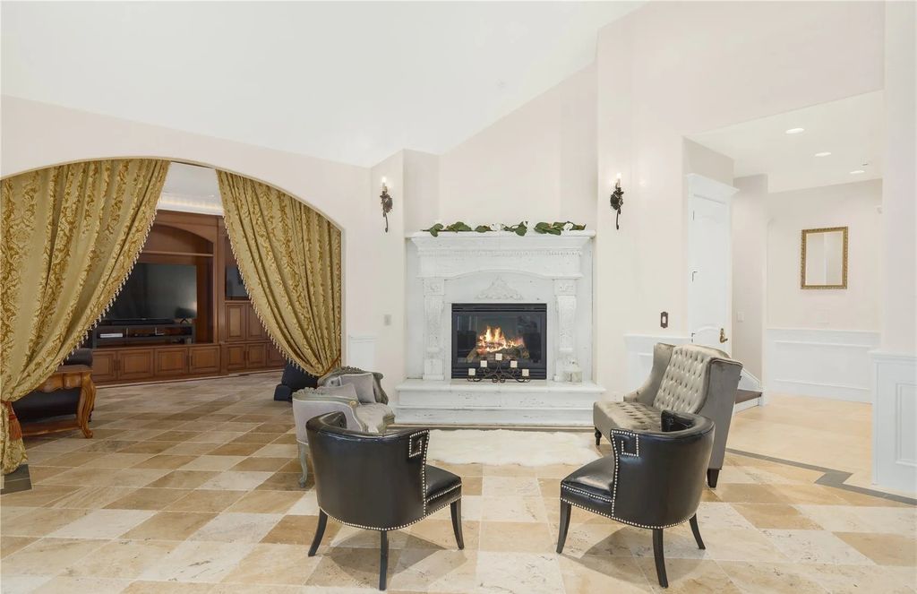 The Estate in Maple Valley boasts striking 22’ ceilings, library, home theater, gym, conference room, and an elevator to all three floors, now available for sale. This home located at 21145 212th Avenue SE, Maple Valley, Washington