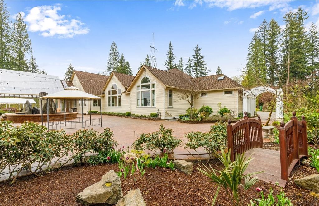 The Estate in Maple Valley boasts striking 22’ ceilings, library, home theater, gym, conference room, and an elevator to all three floors, now available for sale. This home located at 21145 212th Avenue SE, Maple Valley, Washington