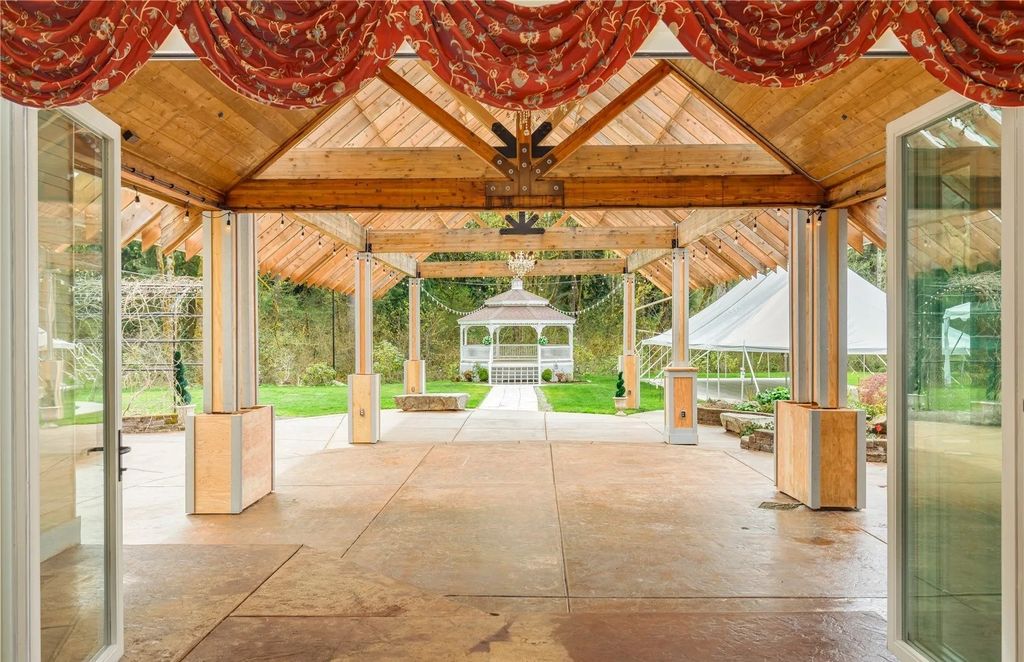 The Estate in Maple Valley boasts striking 22’ ceilings, library, home theater, gym, conference room, and an elevator to all three floors, now available for sale. This home located at 21145 212th Avenue SE, Maple Valley, Washington