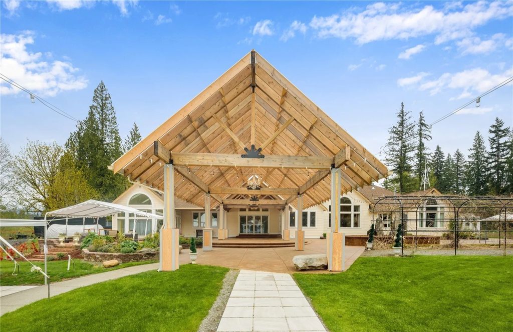 The Estate in Maple Valley boasts striking 22’ ceilings, library, home theater, gym, conference room, and an elevator to all three floors, now available for sale. This home located at 21145 212th Avenue SE, Maple Valley, Washington