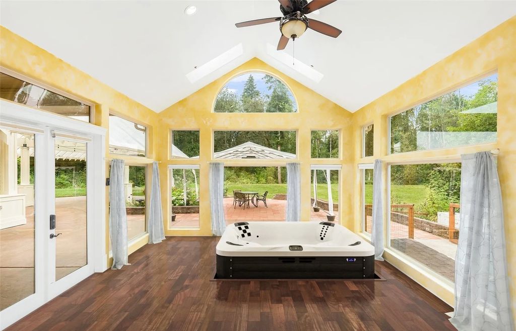 The Estate in Maple Valley boasts striking 22’ ceilings, library, home theater, gym, conference room, and an elevator to all three floors, now available for sale. This home located at 21145 212th Avenue SE, Maple Valley, Washington