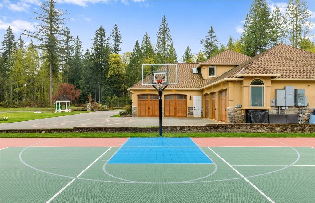 The Estate in Maple Valley boasts striking 22’ ceilings, library, home theater, gym, conference room, and an elevator to all three floors, now available for sale. This home located at 21145 212th Avenue SE, Maple Valley, Washington