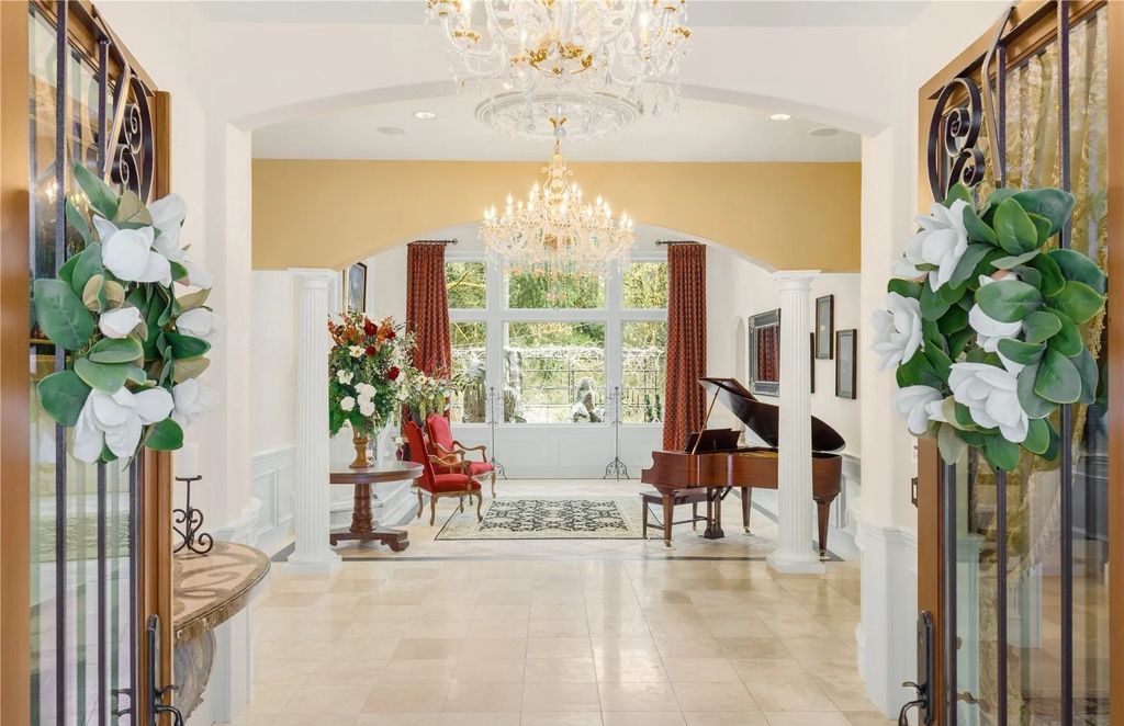 The Estate in Maple Valley boasts striking 22’ ceilings, library, home theater, gym, conference room, and an elevator to all three floors, now available for sale. This home located at 21145 212th Avenue SE, Maple Valley, Washington