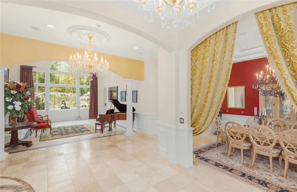 The Estate in Maple Valley boasts striking 22’ ceilings, library, home theater, gym, conference room, and an elevator to all three floors, now available for sale. This home located at 21145 212th Avenue SE, Maple Valley, Washington