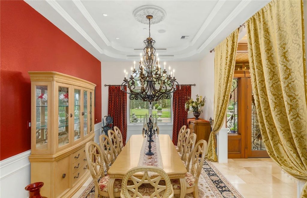 The Estate in Maple Valley boasts striking 22’ ceilings, library, home theater, gym, conference room, and an elevator to all three floors, now available for sale. This home located at 21145 212th Avenue SE, Maple Valley, Washington