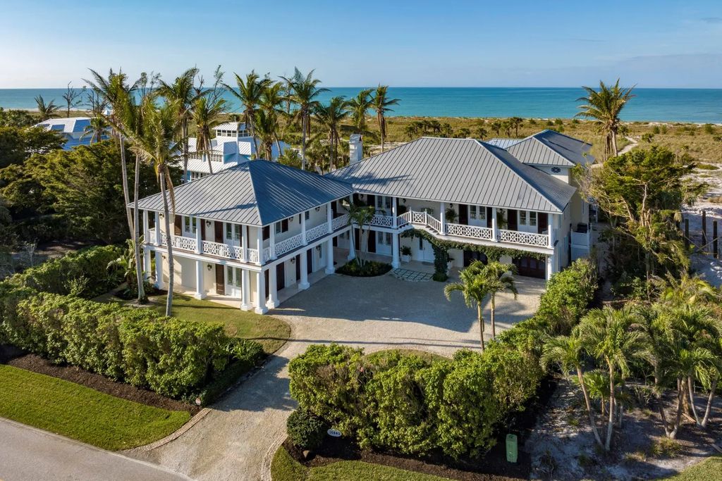 16440 Gulf Shores Drive, Boca Grande, Florida is a breathtaking home sit on unparalleled location offering privacy and luxurious coastal living with lush tropical landscaping and inviting outdoor spaces, boasting incredible views of the Gulf on one side and Lake Gasparilla on the other.