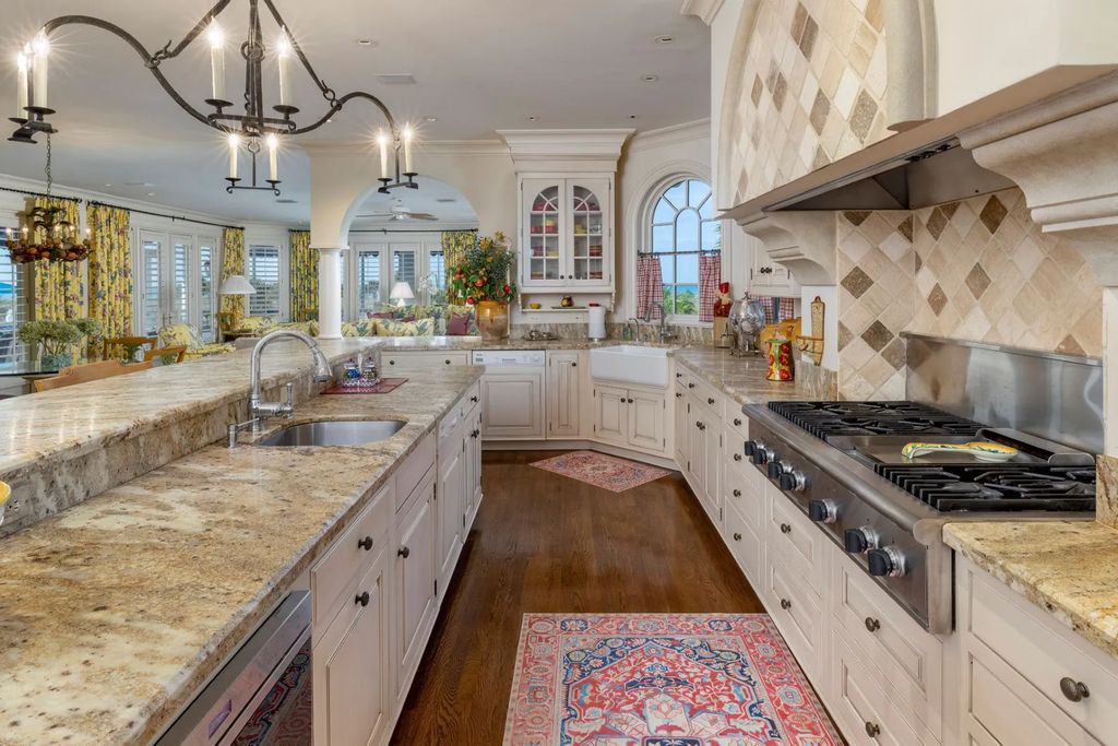 16440 Gulf Shores Drive, Boca Grande, Florida is a breathtaking home sit on unparalleled location offering privacy and luxurious coastal living with lush tropical landscaping and inviting outdoor spaces, boasting incredible views of the Gulf on one side and Lake Gasparilla on the other.