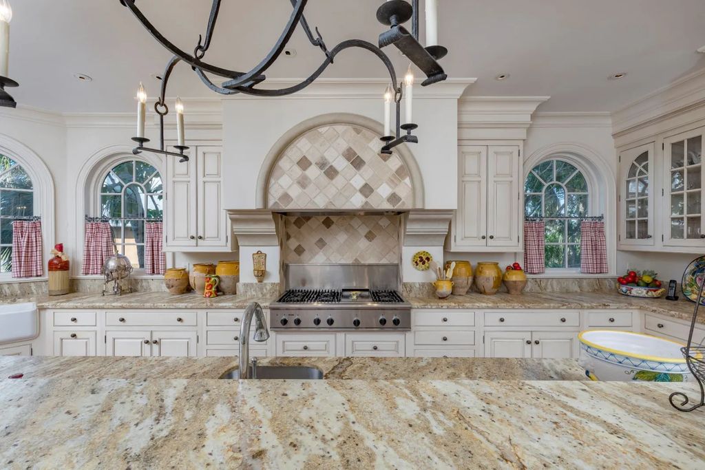 16440 Gulf Shores Drive, Boca Grande, Florida is a breathtaking home sit on unparalleled location offering privacy and luxurious coastal living with lush tropical landscaping and inviting outdoor spaces, boasting incredible views of the Gulf on one side and Lake Gasparilla on the other.