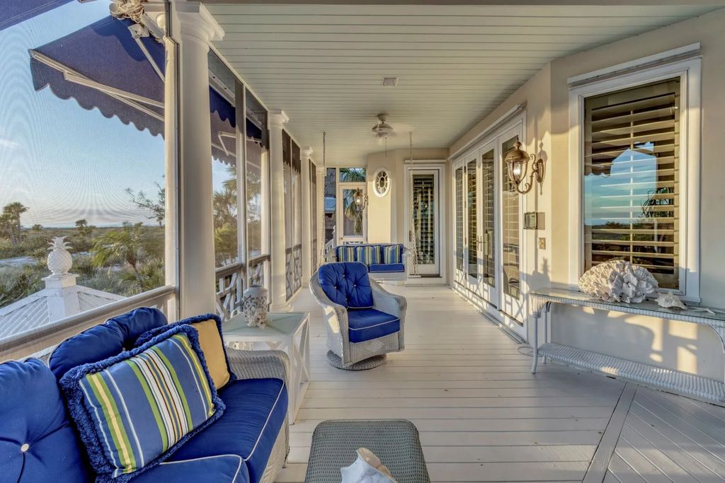 16440 Gulf Shores Drive, Boca Grande, Florida is a breathtaking home sit on unparalleled location offering privacy and luxurious coastal living with lush tropical landscaping and inviting outdoor spaces, boasting incredible views of the Gulf on one side and Lake Gasparilla on the other.