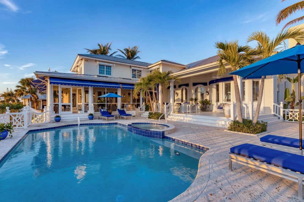 16440 Gulf Shores Drive, Boca Grande, Florida is a breathtaking home sit on unparalleled location offering privacy and luxurious coastal living with lush tropical landscaping and inviting outdoor spaces, boasting incredible views of the Gulf on one side and Lake Gasparilla on the other.