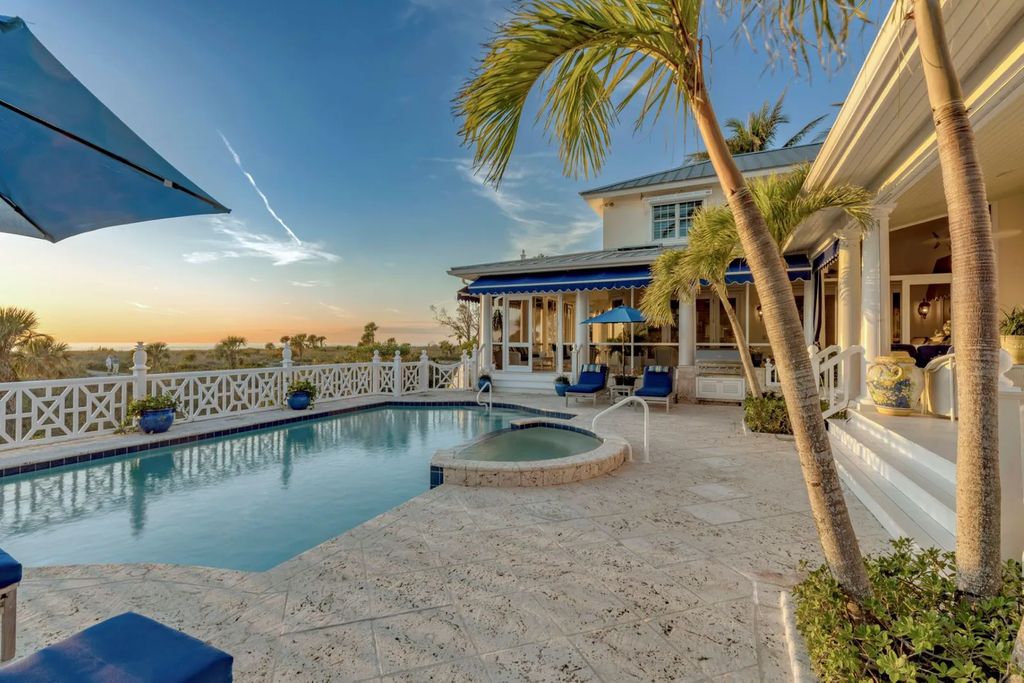 16440 Gulf Shores Drive, Boca Grande, Florida is a breathtaking home sit on unparalleled location offering privacy and luxurious coastal living with lush tropical landscaping and inviting outdoor spaces, boasting incredible views of the Gulf on one side and Lake Gasparilla on the other.