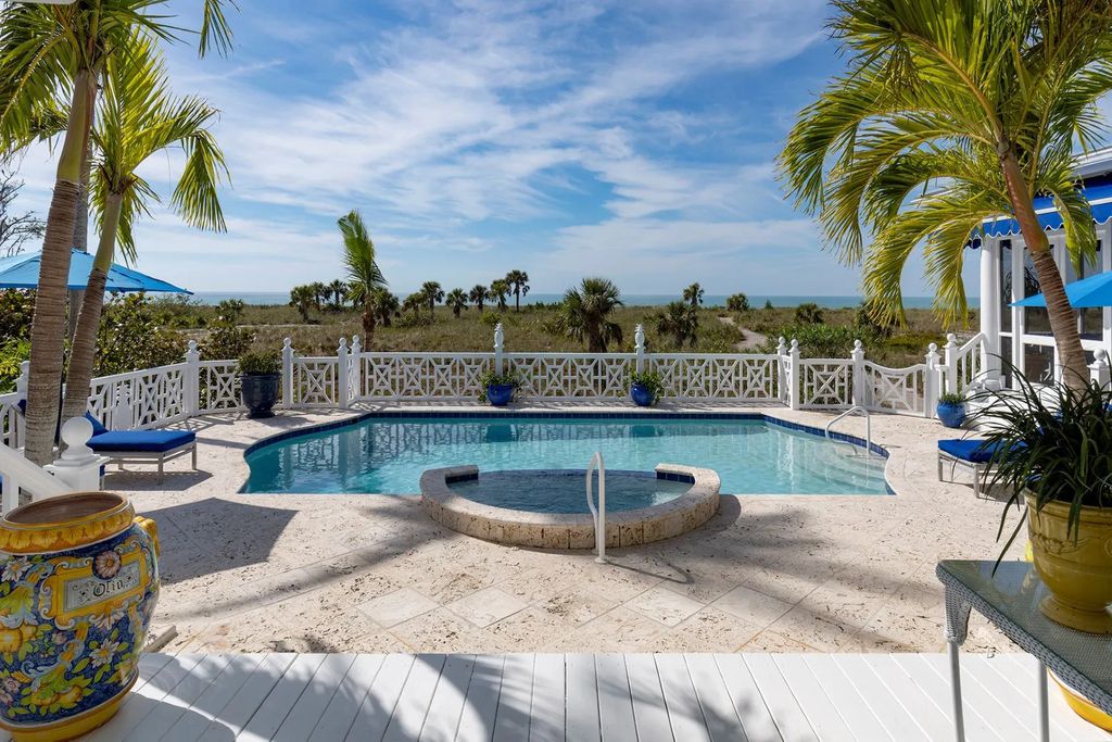 16440 Gulf Shores Drive, Boca Grande, Florida is a breathtaking home sit on unparalleled location offering privacy and luxurious coastal living with lush tropical landscaping and inviting outdoor spaces, boasting incredible views of the Gulf on one side and Lake Gasparilla on the other.