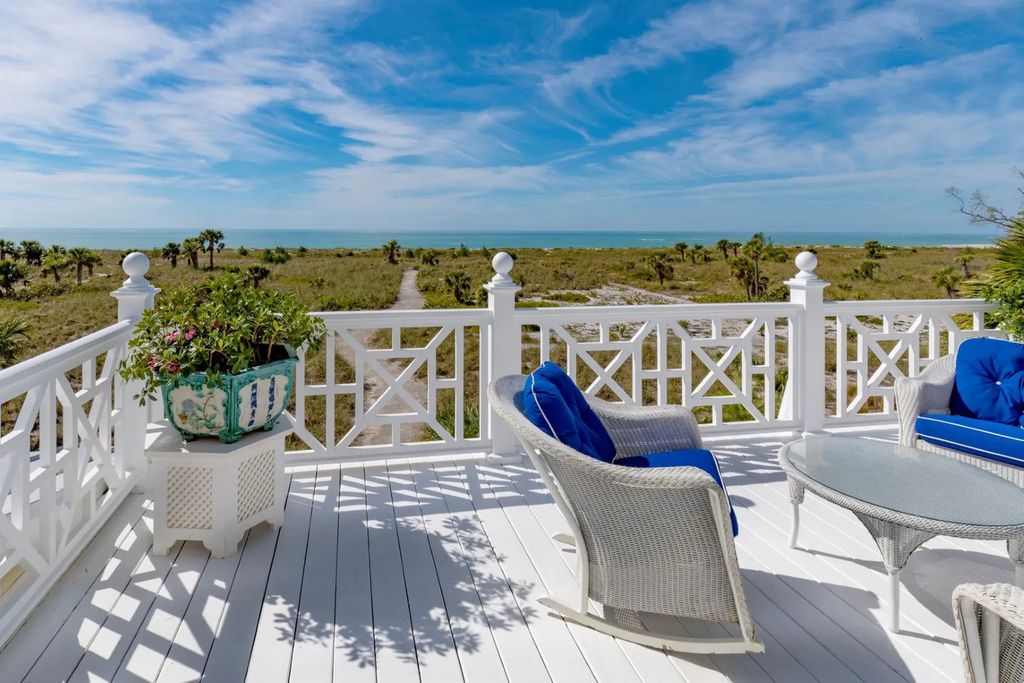 16440 Gulf Shores Drive, Boca Grande, Florida is a breathtaking home sit on unparalleled location offering privacy and luxurious coastal living with lush tropical landscaping and inviting outdoor spaces, boasting incredible views of the Gulf on one side and Lake Gasparilla on the other.