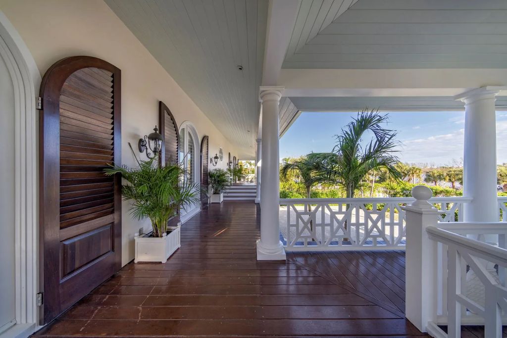 16440 Gulf Shores Drive, Boca Grande, Florida is a breathtaking home sit on unparalleled location offering privacy and luxurious coastal living with lush tropical landscaping and inviting outdoor spaces, boasting incredible views of the Gulf on one side and Lake Gasparilla on the other.