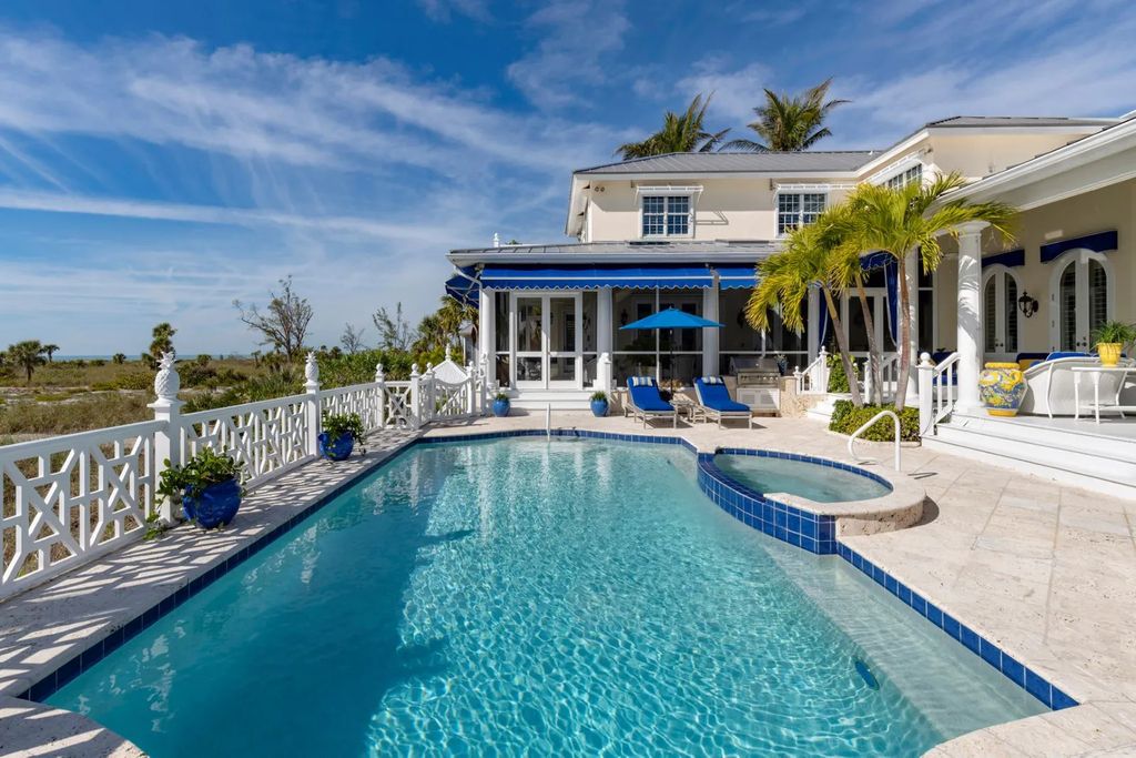 16440 Gulf Shores Drive, Boca Grande, Florida is a breathtaking home sit on unparalleled location offering privacy and luxurious coastal living with lush tropical landscaping and inviting outdoor spaces, boasting incredible views of the Gulf on one side and Lake Gasparilla on the other.