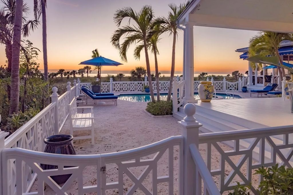 16440 Gulf Shores Drive, Boca Grande, Florida is a breathtaking home sit on unparalleled location offering privacy and luxurious coastal living with lush tropical landscaping and inviting outdoor spaces, boasting incredible views of the Gulf on one side and Lake Gasparilla on the other.