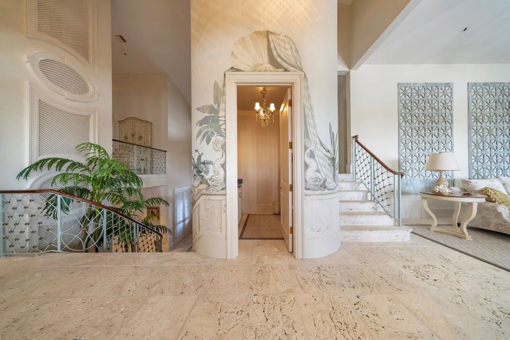 16440 Gulf Shores Drive, Boca Grande, Florida is a breathtaking home sit on unparalleled location offering privacy and luxurious coastal living with lush tropical landscaping and inviting outdoor spaces, boasting incredible views of the Gulf on one side and Lake Gasparilla on the other.