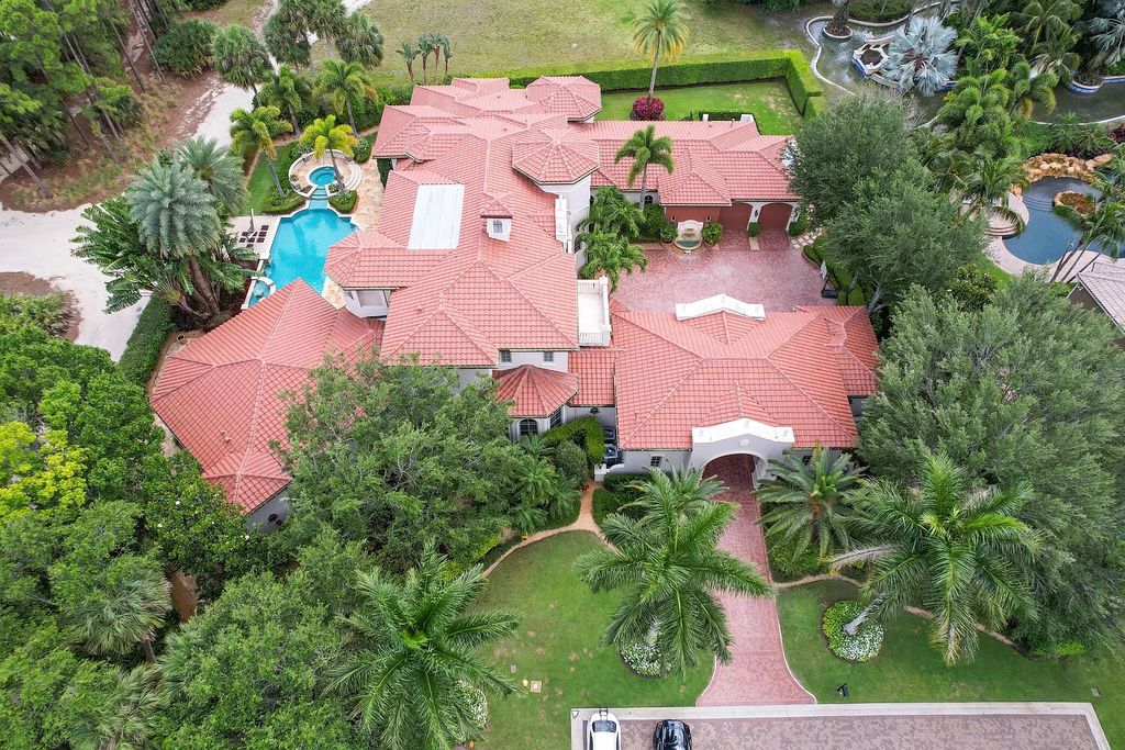 11736 Valeros Court, Palm Beach Gardens, Florida is a special residence in the exclusive Old Palm Golf Club with an amazing array of luxury amenities and design details, amenities include concrete block construction, impact windows and doors, brand new roof, whole home generator, elevator, 5 car garages.