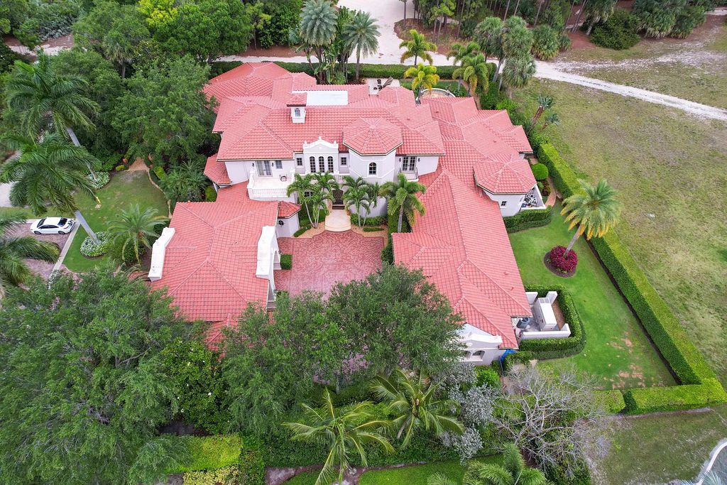 11736 Valeros Court, Palm Beach Gardens, Florida is a special residence in the exclusive Old Palm Golf Club with an amazing array of luxury amenities and design details, amenities include concrete block construction, impact windows and doors, brand new roof, whole home generator, elevator, 5 car garages.