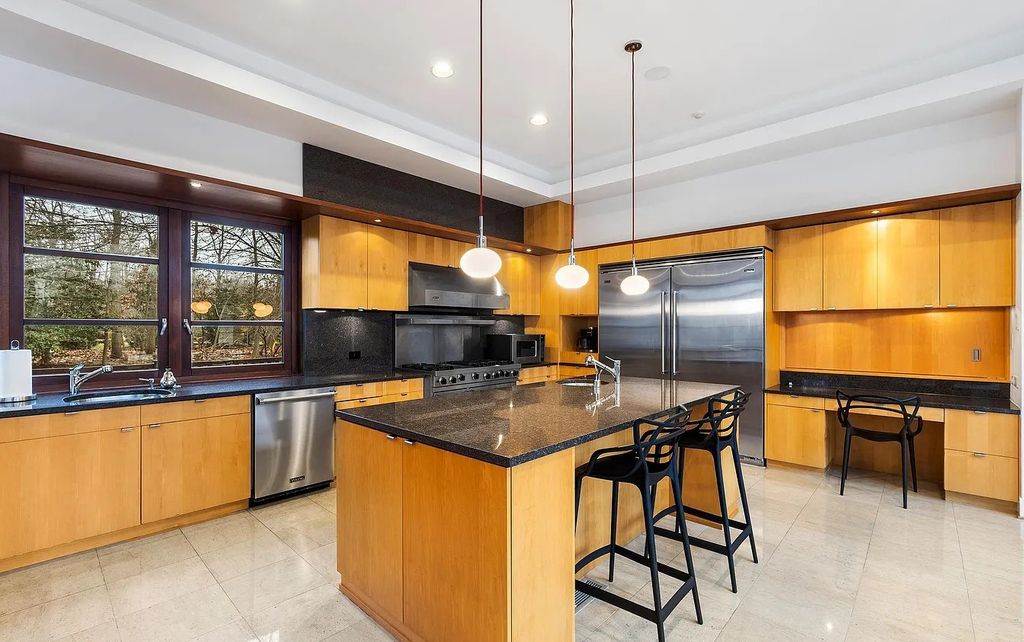 The House in Owings Mill features magnificent wooded views of the 2+ acre site plus 33 or more acres of open space in the valley beyond, now available for sale. This home located at 1 Huntersworth Ct, Owings Mills, Maryland