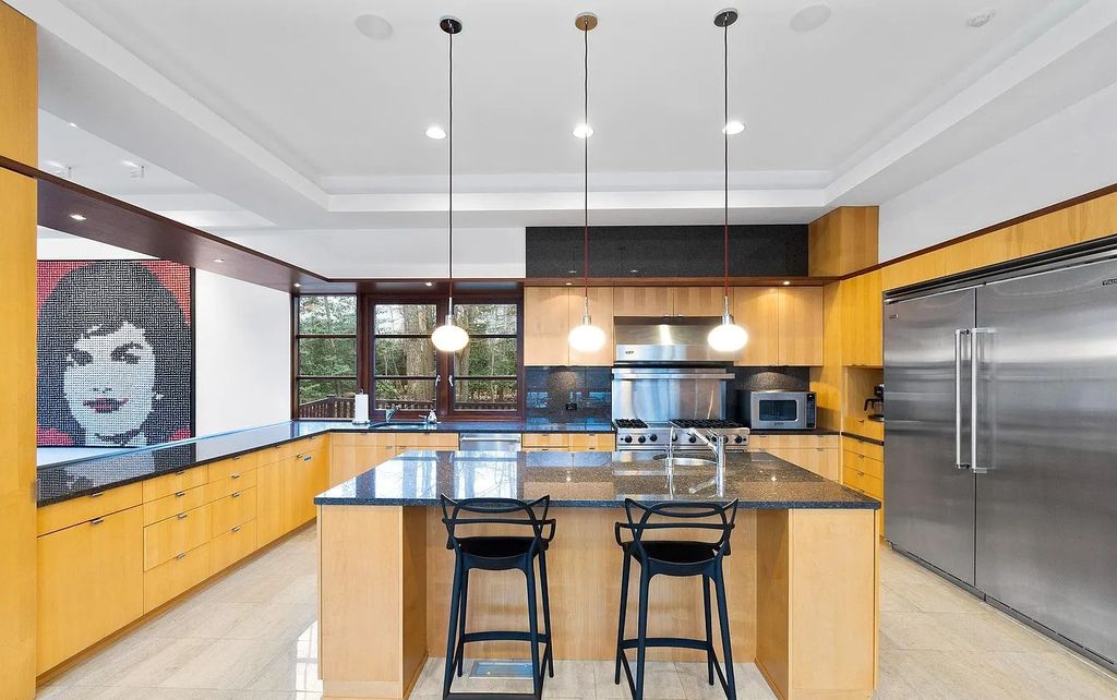 The House in Owings Mill features magnificent wooded views of the 2+ acre site plus 33 or more acres of open space in the valley beyond, now available for sale. This home located at 1 Huntersworth Ct, Owings Mills, Maryland