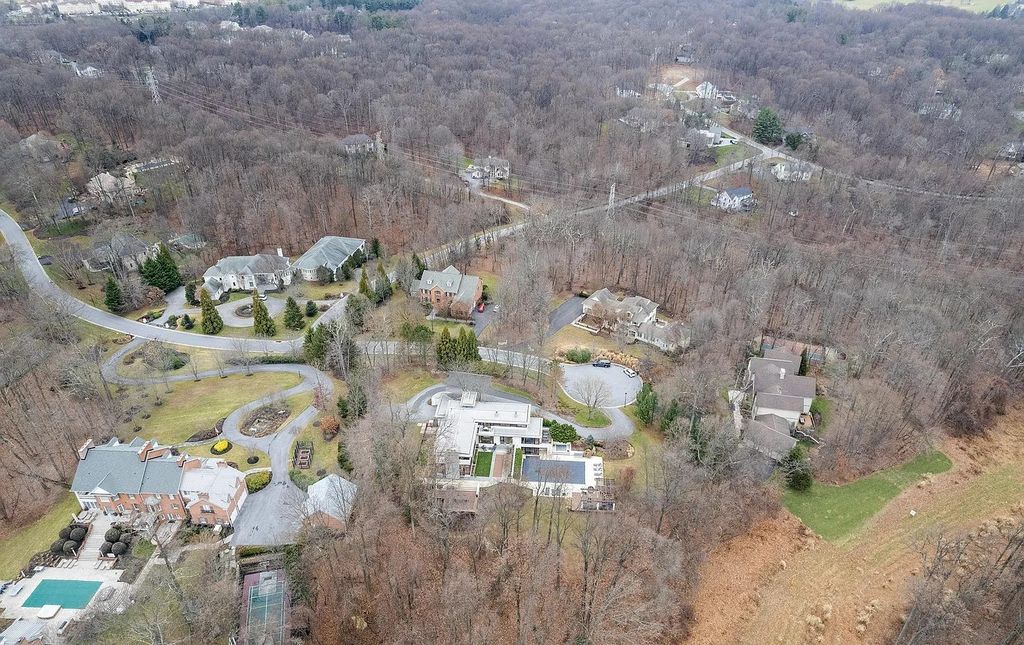 The House in Owings Mill features magnificent wooded views of the 2+ acre site plus 33 or more acres of open space in the valley beyond, now available for sale. This home located at 1 Huntersworth Ct, Owings Mills, Maryland