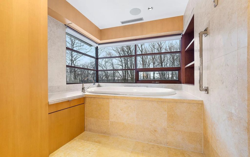 The House in Owings Mill features magnificent wooded views of the 2+ acre site plus 33 or more acres of open space in the valley beyond, now available for sale. This home located at 1 Huntersworth Ct, Owings Mills, Maryland