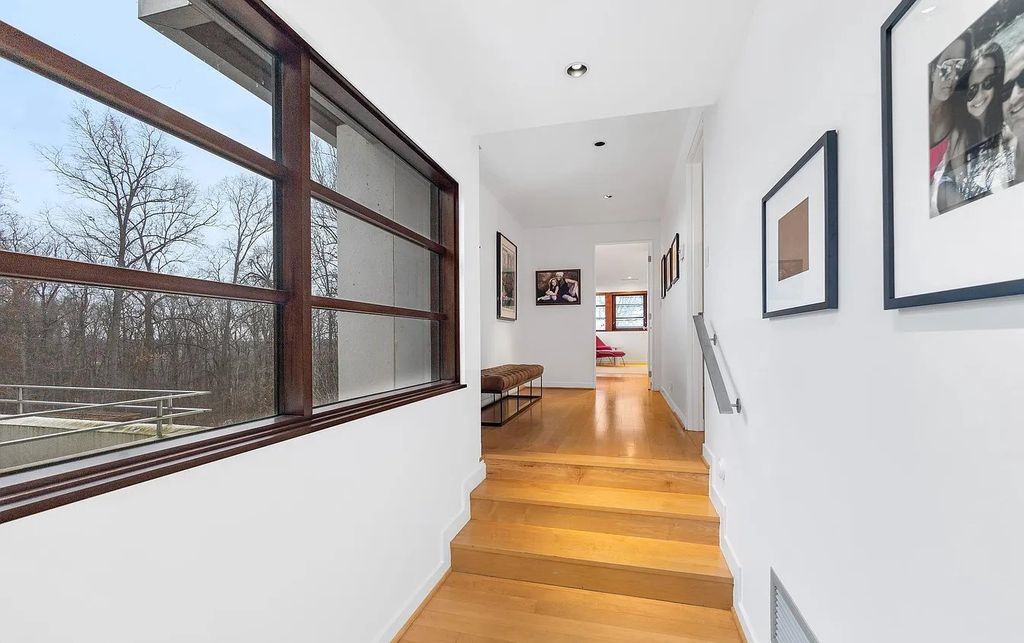 The House in Owings Mill features magnificent wooded views of the 2+ acre site plus 33 or more acres of open space in the valley beyond, now available for sale. This home located at 1 Huntersworth Ct, Owings Mills, Maryland