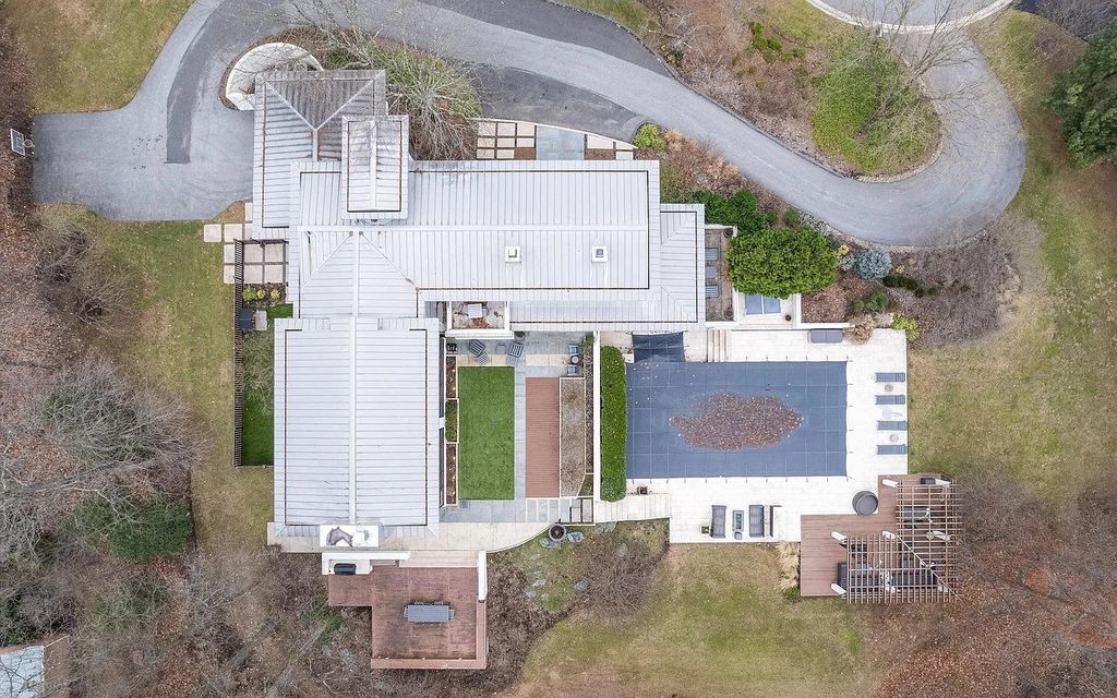 The House in Owings Mill features magnificent wooded views of the 2+ acre site plus 33 or more acres of open space in the valley beyond, now available for sale. This home located at 1 Huntersworth Ct, Owings Mills, Maryland