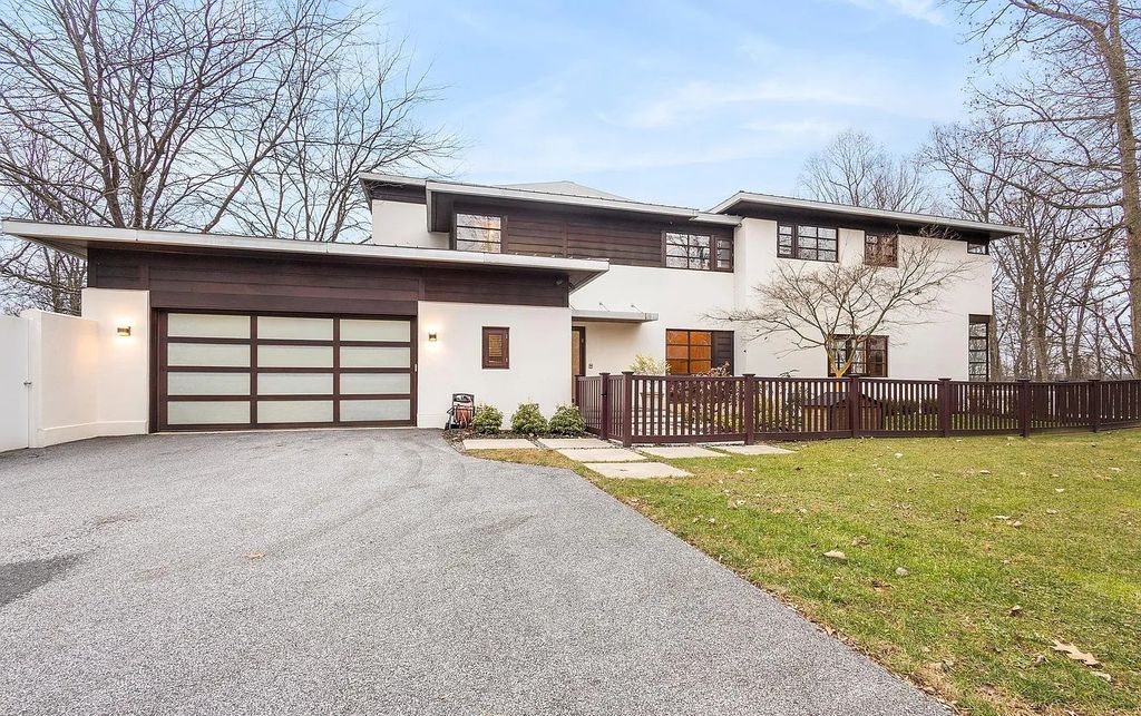 The House in Owings Mill features magnificent wooded views of the 2+ acre site plus 33 or more acres of open space in the valley beyond, now available for sale. This home located at 1 Huntersworth Ct, Owings Mills, Maryland