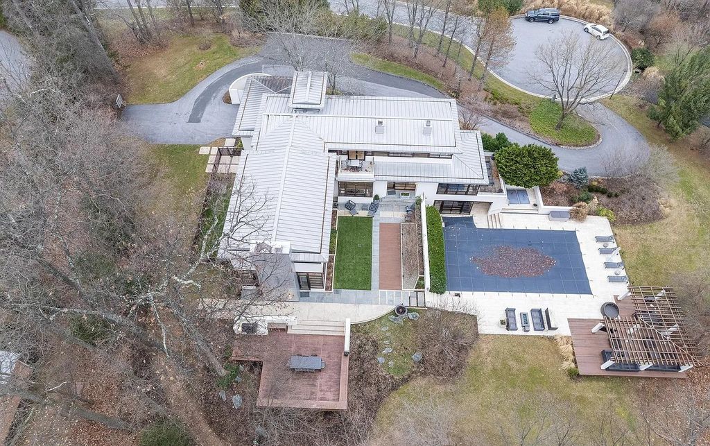 The House in Owings Mill features magnificent wooded views of the 2+ acre site plus 33 or more acres of open space in the valley beyond, now available for sale. This home located at 1 Huntersworth Ct, Owings Mills, Maryland