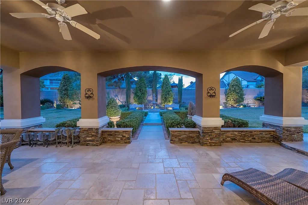 7600 Silver Meadow Court, Las Vegas, Nevada is a resort style estate in an exclusive gated enclave with a generous circular drive, a spacious living room punctuated by a stunning wrought iron floating staircase, a gourmet kitchen, venetian gardens, resort guest house and more.