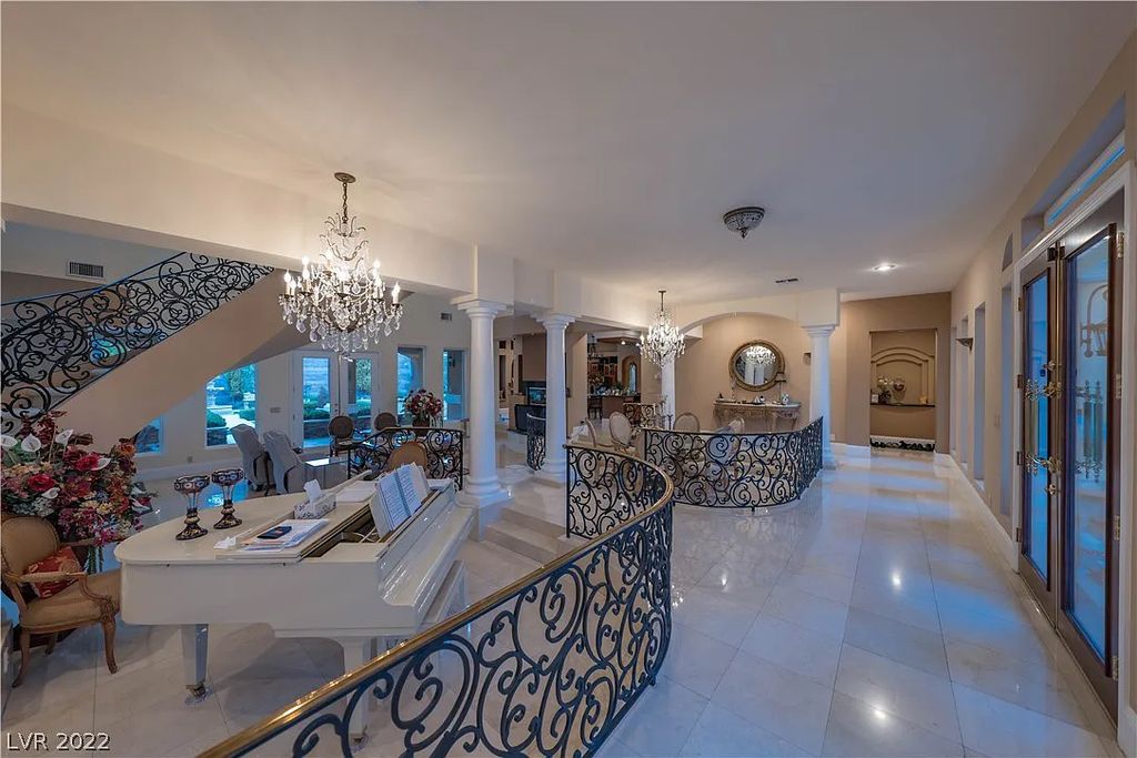 7600 Silver Meadow Court, Las Vegas, Nevada is a resort style estate in an exclusive gated enclave with a generous circular drive, a spacious living room punctuated by a stunning wrought iron floating staircase, a gourmet kitchen, venetian gardens, resort guest house and more.