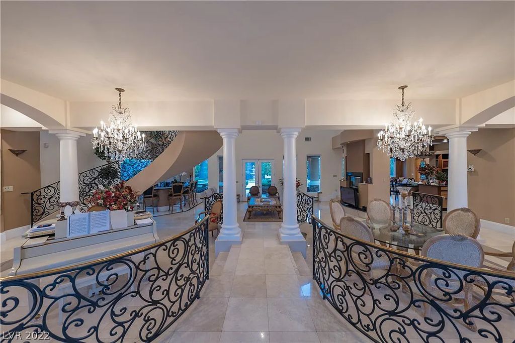 7600 Silver Meadow Court, Las Vegas, Nevada is a resort style estate in an exclusive gated enclave with a generous circular drive, a spacious living room punctuated by a stunning wrought iron floating staircase, a gourmet kitchen, venetian gardens, resort guest house and more.