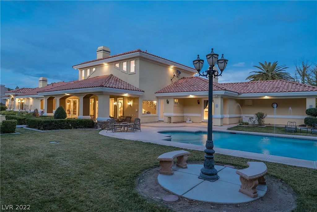7600 Silver Meadow Court, Las Vegas, Nevada is a resort style estate in an exclusive gated enclave with a generous circular drive, a spacious living room punctuated by a stunning wrought iron floating staircase, a gourmet kitchen, venetian gardens, resort guest house and more.