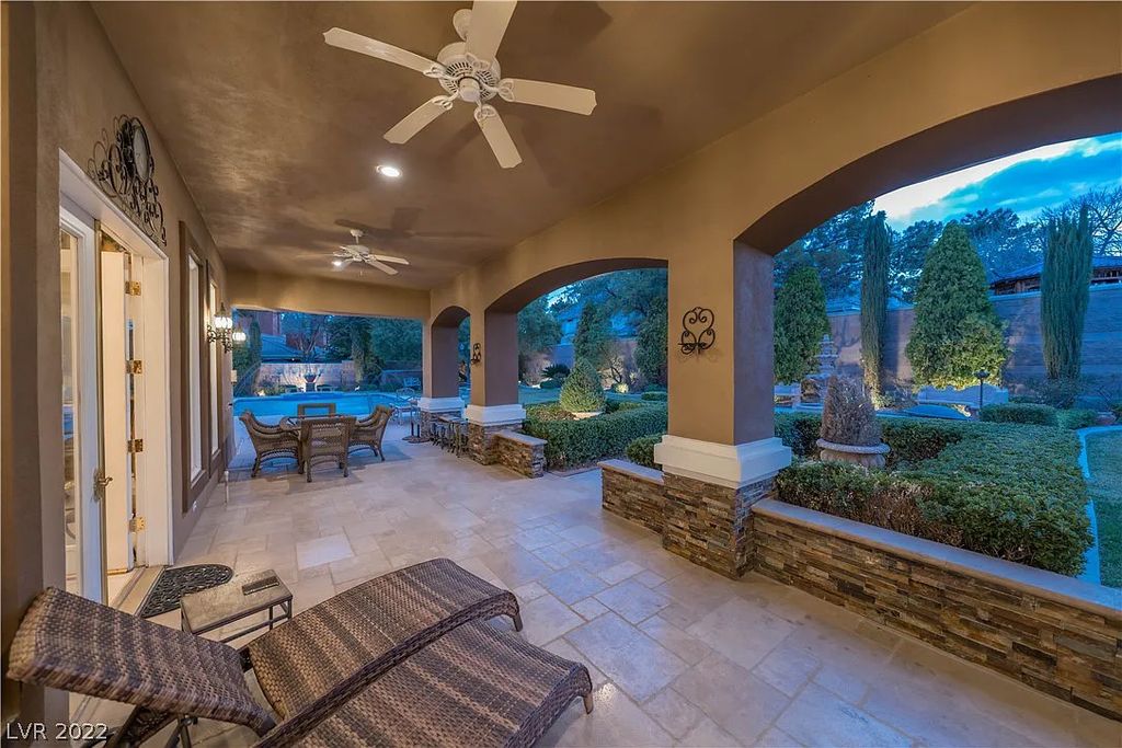 7600 Silver Meadow Court, Las Vegas, Nevada is a resort style estate in an exclusive gated enclave with a generous circular drive, a spacious living room punctuated by a stunning wrought iron floating staircase, a gourmet kitchen, venetian gardens, resort guest house and more.