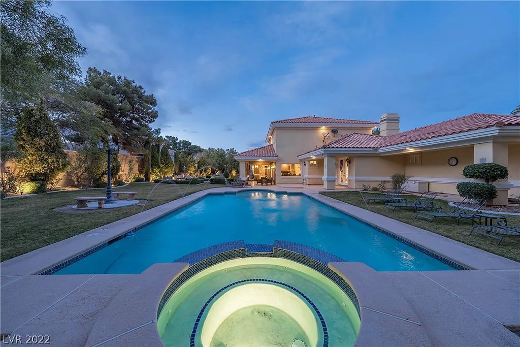 7600 Silver Meadow Court, Las Vegas, Nevada is a resort style estate in an exclusive gated enclave with a generous circular drive, a spacious living room punctuated by a stunning wrought iron floating staircase, a gourmet kitchen, venetian gardens, resort guest house and more.